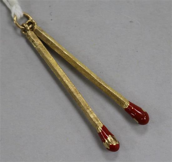 A 9ct gold and red enamel twin matchstick pendant, 40mm.